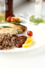 Chicken cutlets with buckwheat, herbs, ketchup and tomatoes