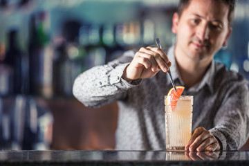 Professional barman making  alcoholic cocktail drink paloma