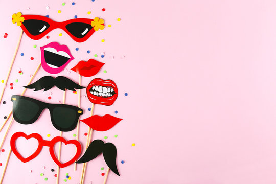 Different Photo Booth Props On Bright Pink Background. Paper Moustache, Lips And Glasses On Stick. Party Kit For Birthday, Wedding Or Corporate Event Celebration. Flat Lay, Copy Space, Top View.