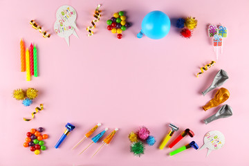 Birthday celebration attributes. Party horns, colorful confetti, balloons & other items on bright pink background. Close up, top view, copy space, flat lay. Happy birthday text on small speech bubble.