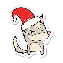 distressed sticker of a tired wolf cartoon wearing xmas hat
