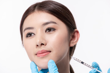 Surgery concept. The doctor cosmetologist makes the Rejuvenating facial injections procedure for...