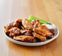 plate of bbq chicken wings with copy space composition