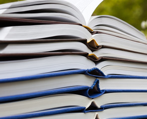 Pile of thick open books