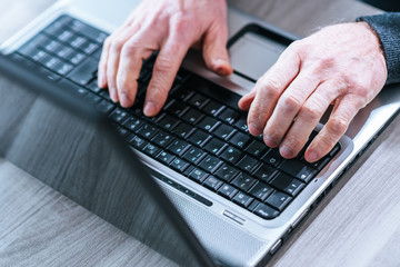 Male hands using a laptop