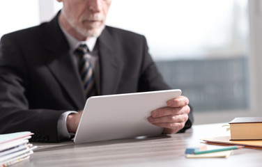 Senior businessman using a digital tablet