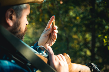 Hunter with shotgun gun on hunt. Closed and open hunting season. Big game. Gun rifle and cartridge...