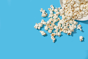 Popcorn on blue background. Bright backdrop.