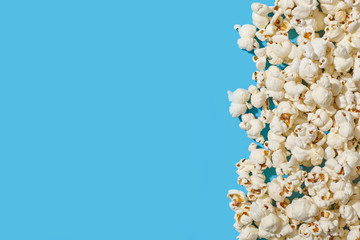 A pile of popcorn on blue background.
