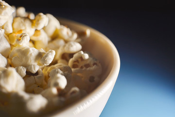 Closeup of dried popcorn in bowl. Background with copy space.