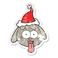 distressed sticker cartoon of a dog face panting wearing santa hat