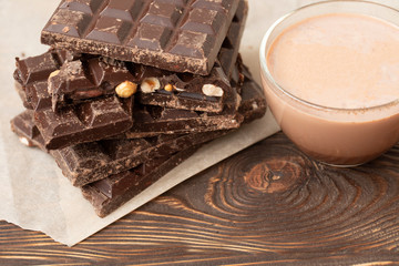 Noble dark chocolate on a wooden table in vintage style 