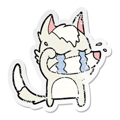distressed sticker of a cartoon crying wolf rubbing eyes