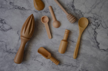 Wooden kitchen utensils on marble table in the kitchen. Top view