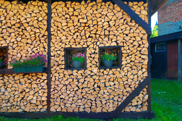 Firewood stack with flowers.
