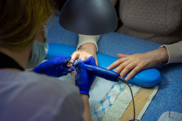 Nail polish remover, beauty salon, manicure.treatment hand and nail care, the woman to a beautician for a manicure