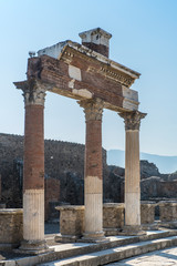 Fototapeta premium POMPEII, ITALY - 8 August 2015: Ruins of antique roman temple in Pompeii near volcano Vesuvius, Naples, Italy