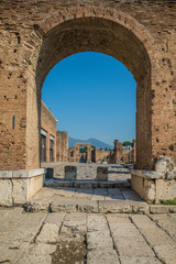 POMPEII, ITALY - 8 August 2015: Ruins of antique roman temple in Pompeii near volcano Vesuvius, Naples, Italy