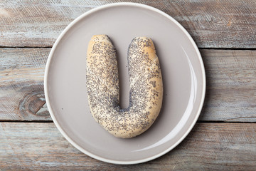 Poppy seed croissant bow bread roll on plate
