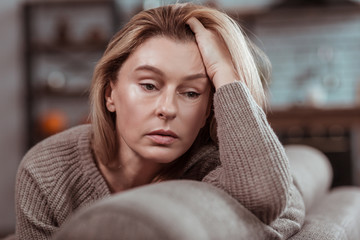 Pleasant appealing woman feeling depressed after divorce