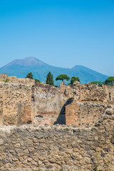Fototapeta na wymiar POMPEII, ITALY - 8 August 2015: Ruins of antique roman temple in Pompeii near volcano Vesuvius, Naples, Italy
