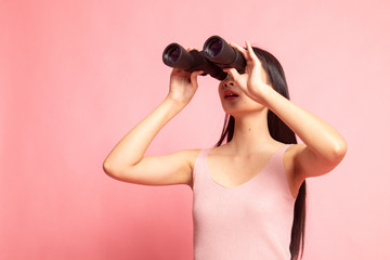 Young Asian woman with binoculars.