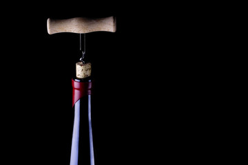 Corkscrew and bottle of wine.