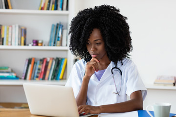African american medical student learning at computer