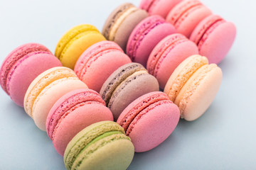 Obraz premium Cake macaron or macaroon on turquoise background from above, almond cookies, pastel colors