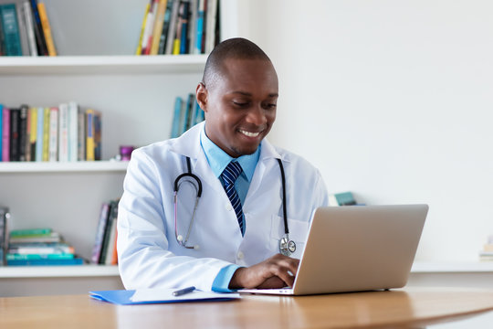 African American General Practitioner Working At Computer