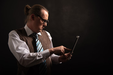 Funny nerd or geek looking on tablet with empty placeholder