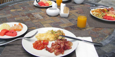 Hotel breakfast on outdoor table.