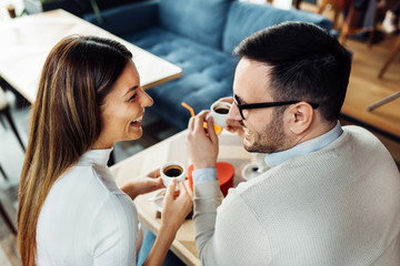 Young couple having fun at cafe