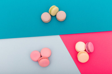 Top view of colorful macaron or macaroon on different color background. selective focus. Flat lay