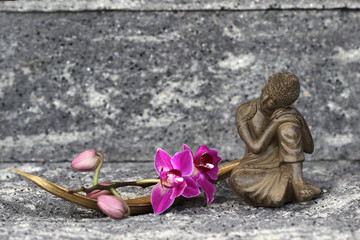 Buddha with orchid blossom