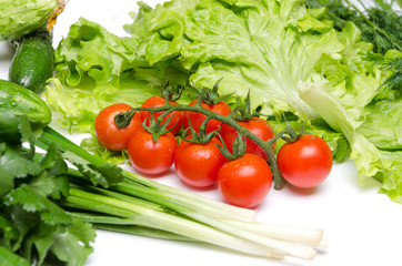 Fresh ingredients for salad.Concept of preparation for cooking.Spring vegetables.Raw tomatoes,lettuce leaves,cucumber,cilantro,shallot