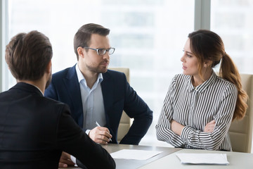 Concerned unconvinced hr managers talking feeling doubtful about hiring candidate