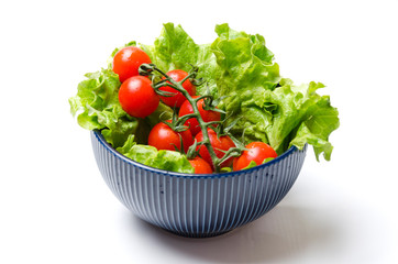 Raw fresh tomatoes and green lettuce in the bowl.Preparation for cooking salad.Simply, easy and fast salad