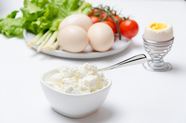 Delicious and healthy breakfast.Cottage cheese,boiled eggs and various of vegetables.The morning table
