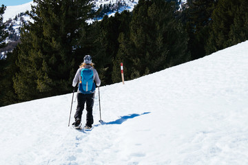 Fototapeta na wymiar A woman is snowshoeing in the italian alps /Vinschgau/ Tirol