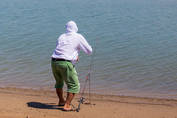 A man catches fish on the lake