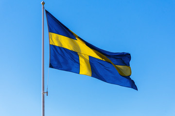 Swedish flag  against the blue sky