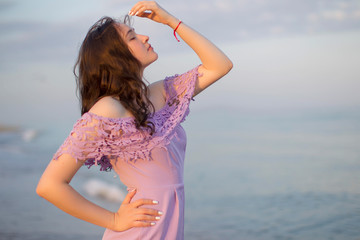 Fototapeta na wymiar Beautiful young girl on the background of the sea