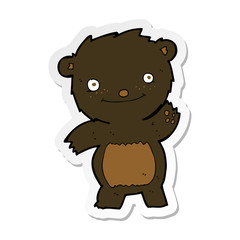 sticker of a cartoon waving black bear cub