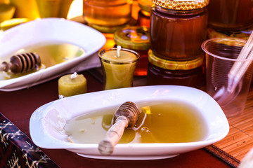 Honey in markeHoney in market. Jars, honey sticks and candles. Natural organic product.t. Jars, honey sticks and candles. Natural organic product.