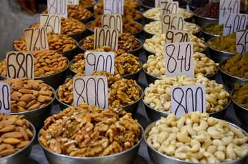 Top view of dry fruit samples nicely stacked placed in bowls and put on display in a shop in old Delhi spice market Khari Bouli, Chandni Chowk, Old Delhi, India