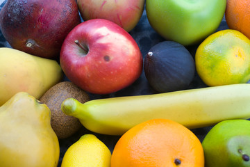 Assortment of different various organic fruits. Fresh food concept, colorful bright background. Composition of assorted fresh ripe raw organic fruits. Healthy lifestyle, dieting concept, clean eating.