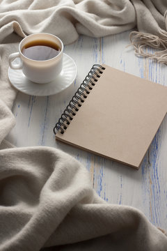 Cup with Coffee, Notepad on the White Wooden Table. Concept of Spring