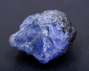 Soft blue violet rough TANZANITE from Tanzania isolated on black background.