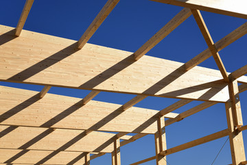construction frame made of wood against blue sky